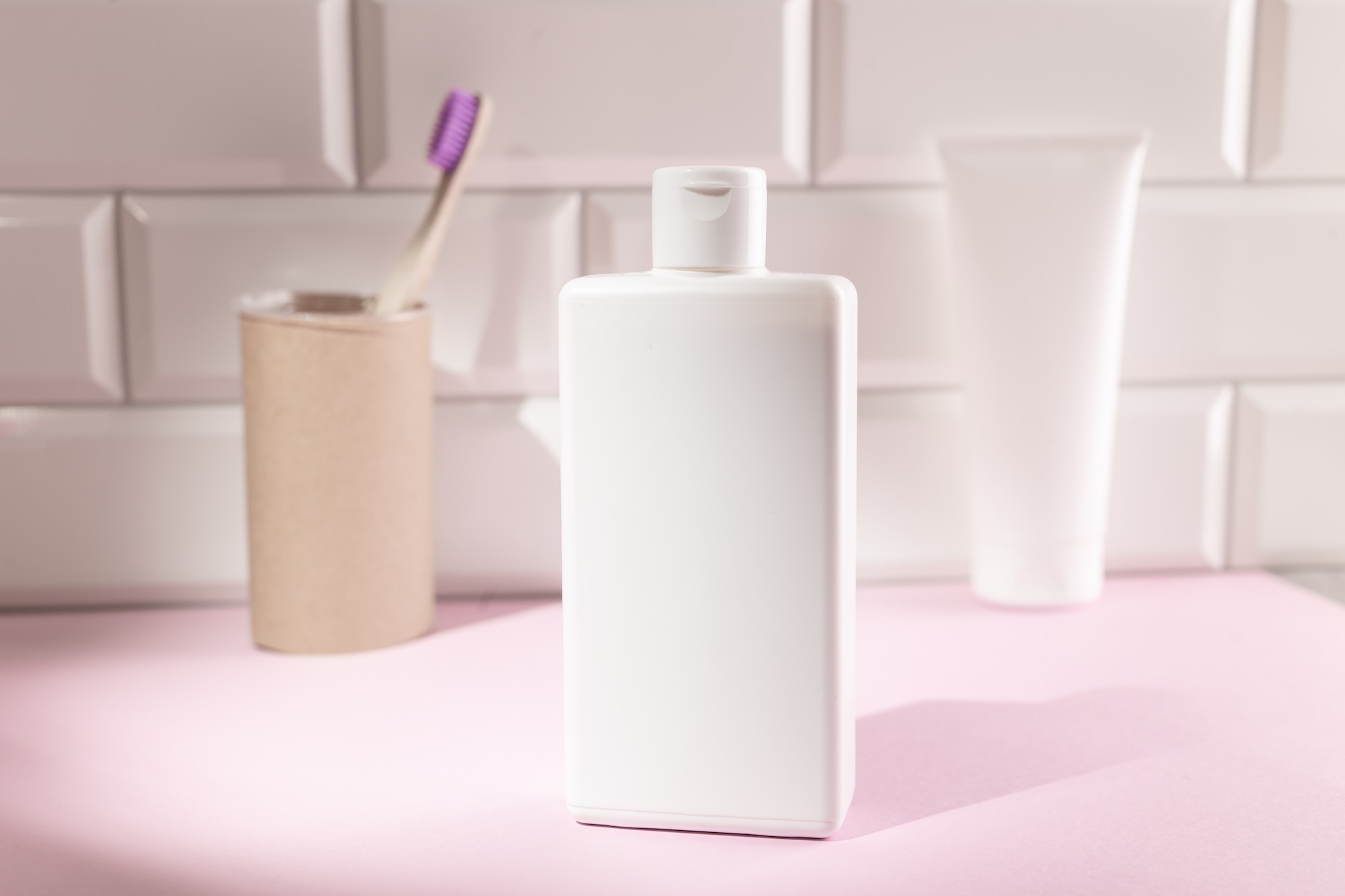 White cosmetic bottles in a bathroom, mock up for your design